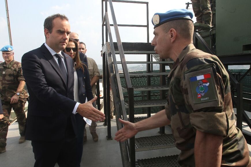 French Defence Minister Sebastien Lecornu (L) visits his country's contingent in the UN peacekeeping force in south Lebanon, telling them their mission has never been so important