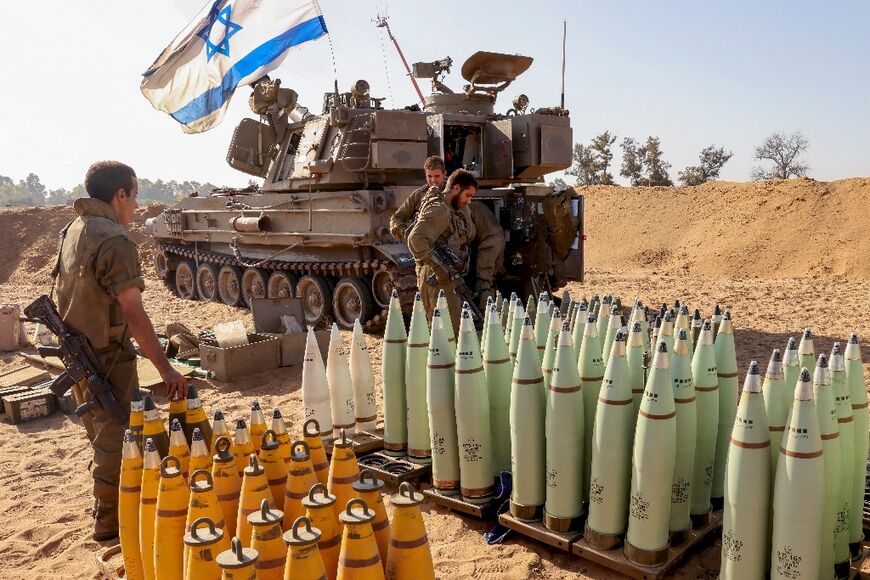 An Israeli artillery crew prepares shells at a position near the border with the Gaza Strip in southern Israel