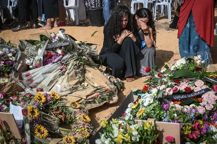 Relatives and friends of David Carroll who was killed by Palestinian Hamas militants on October 7, in Kibbutz Beeri, mourn during his funeral in Revivim on October 22, 2023, amid the ongoing battles between Israel and the Palestinian group Hamas