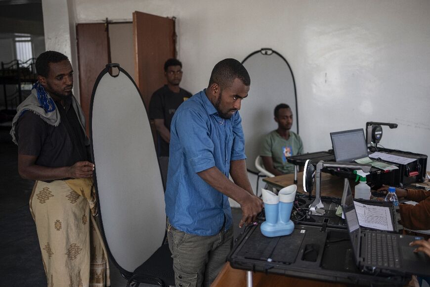 An Ethiopian returnee gets his fingerprints scanned to get a temporary ID at the International Organization for Migration (IOM) transit centre in Addis Ababa
