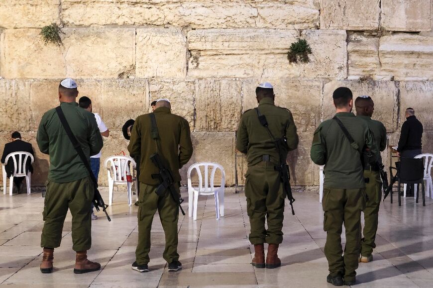 Israeli soldiers pray at the Western Wall in Jerusalem, on November 15, 2023, amid ongoing battles between Israel and  Hamas.