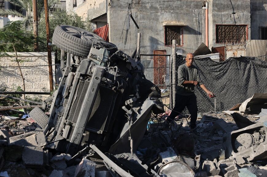 A Palestinian man inspects debris following an Israeli strike in Rafah in the southern Gaza Strip
