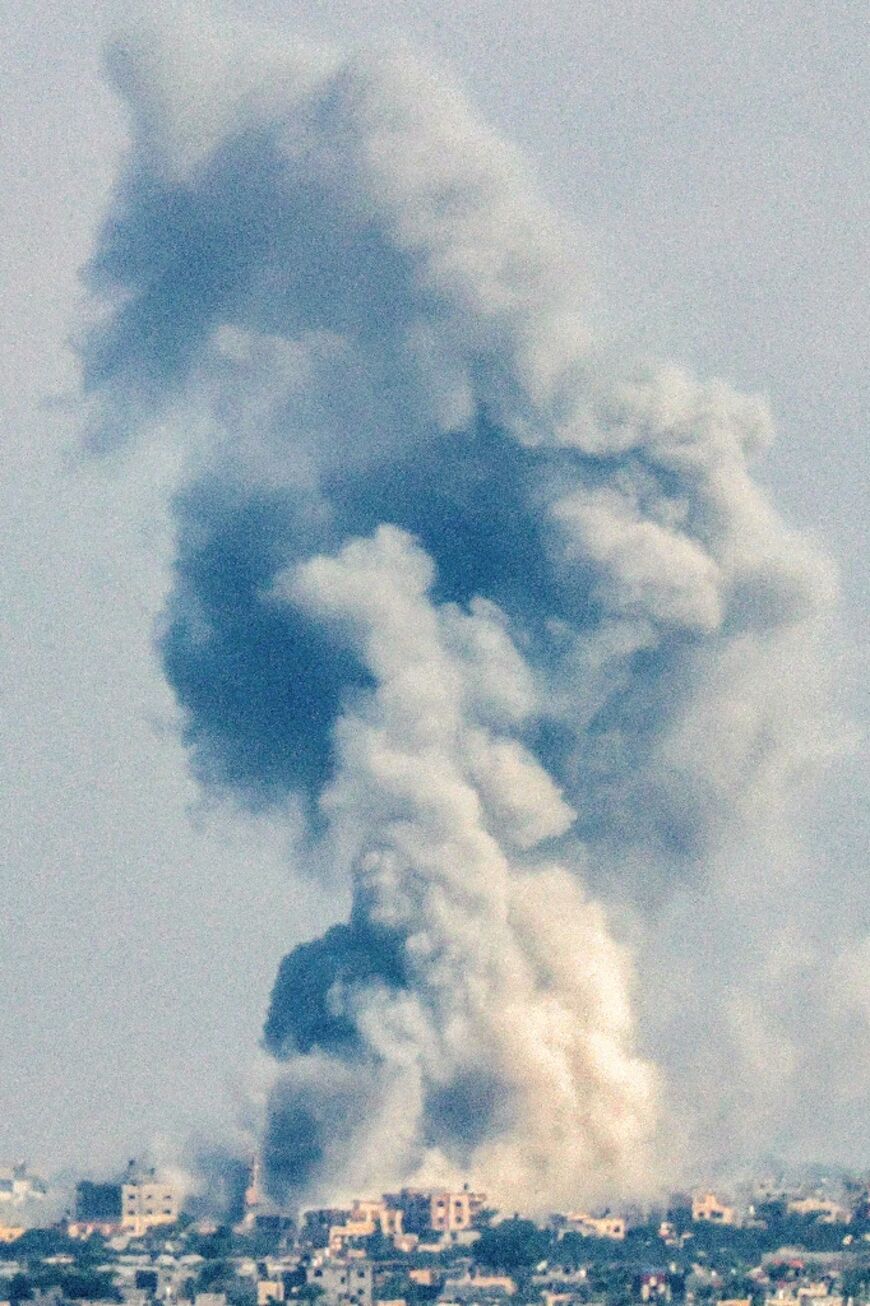 A smoke plume erupts during Israeli bombardment in Rafah in the southern Gaza Strip on November 14, 2023