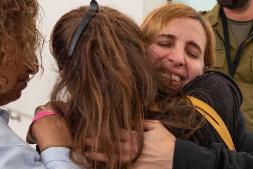 This handout picture former captive Danielle Aloni embracing family members upon her arrival at a hospital in Israel