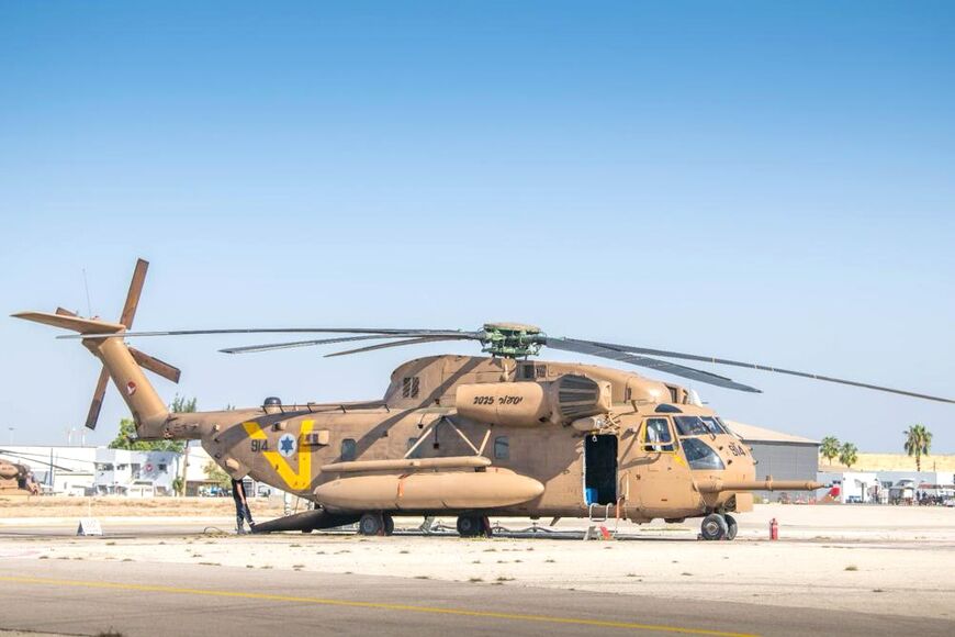 An army helicopter waits to ferry freed hostages to hospitals around Israel, where the delicate process of helping them to come to terms with the traum of their captivity will begin
