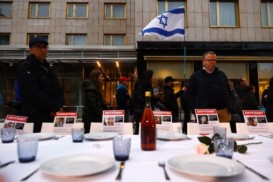 A person waves an Israeli flag at an event in Germany in solidarity with hostages taken in the Hamas attack