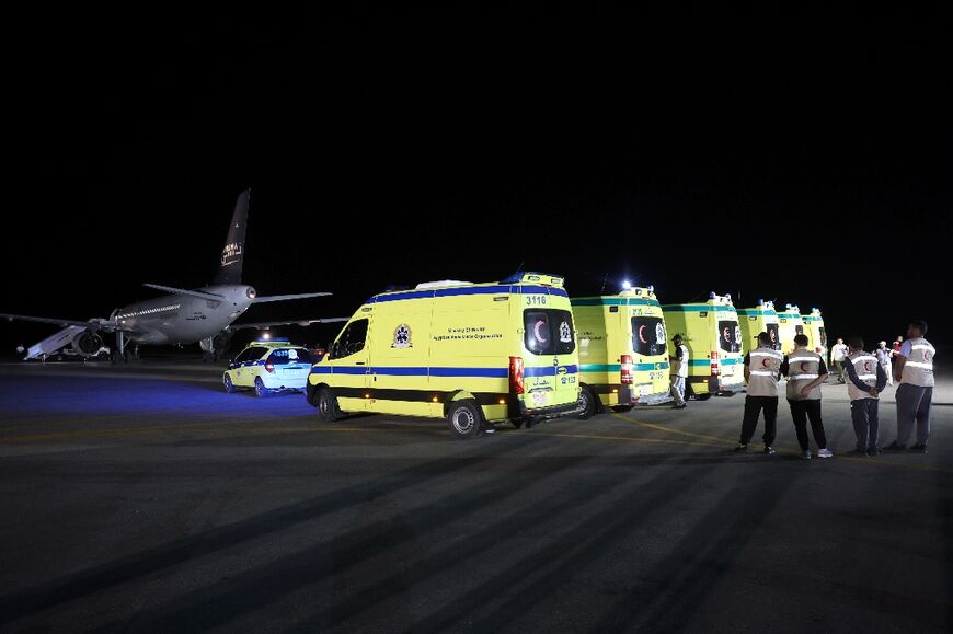 The children were stretchered from ambulances onto a plane at Arish airport in Egypt
