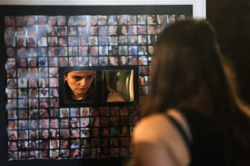 A woman looks at portraits of Israeli hostages taken by Palestinian militants