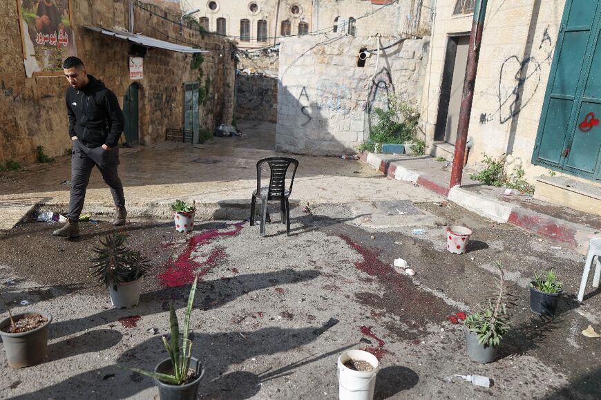 A young man walks past the spot where four Palestinians were reportedly killed in an Israeli drone strike