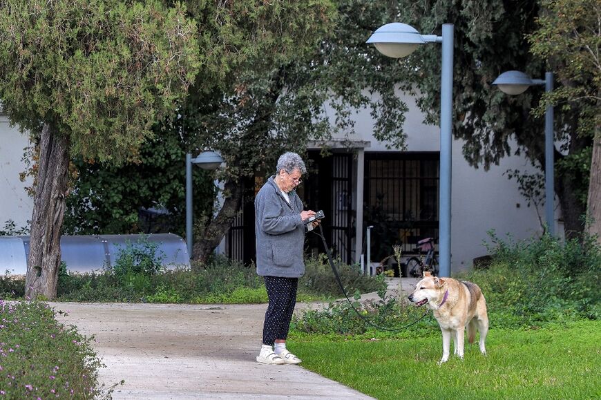 An Israeli from Nahal Oz walks her dog in Mishmar Haemek