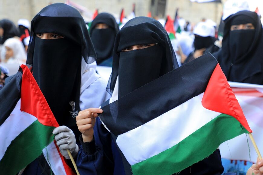 Yemeni women hold up Palestinian flags during a protest in front of the United Nations office in Sanaa on December 10, 2023 