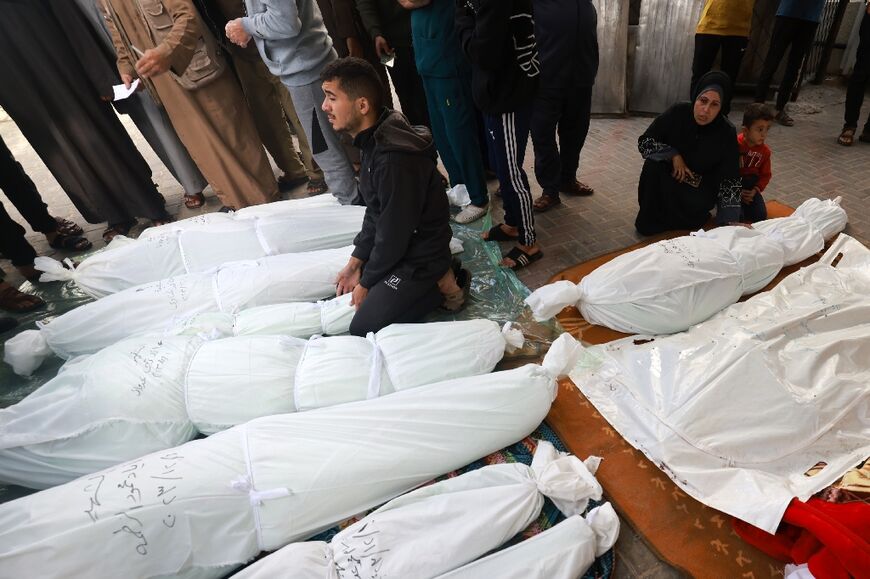 People gather to identify the bodies of family members in Rafah's Al-Najjar hospital on December 1