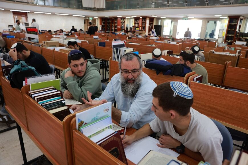 The main hall of Sderot's yeshiva is bustling with students even as most of the down remains empty during war