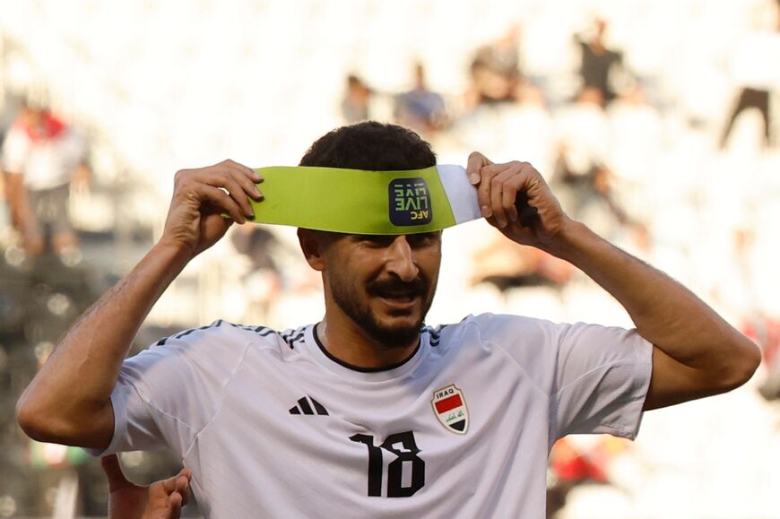 Iraq's forward Aymen Hussein celebrates scoring his team's second