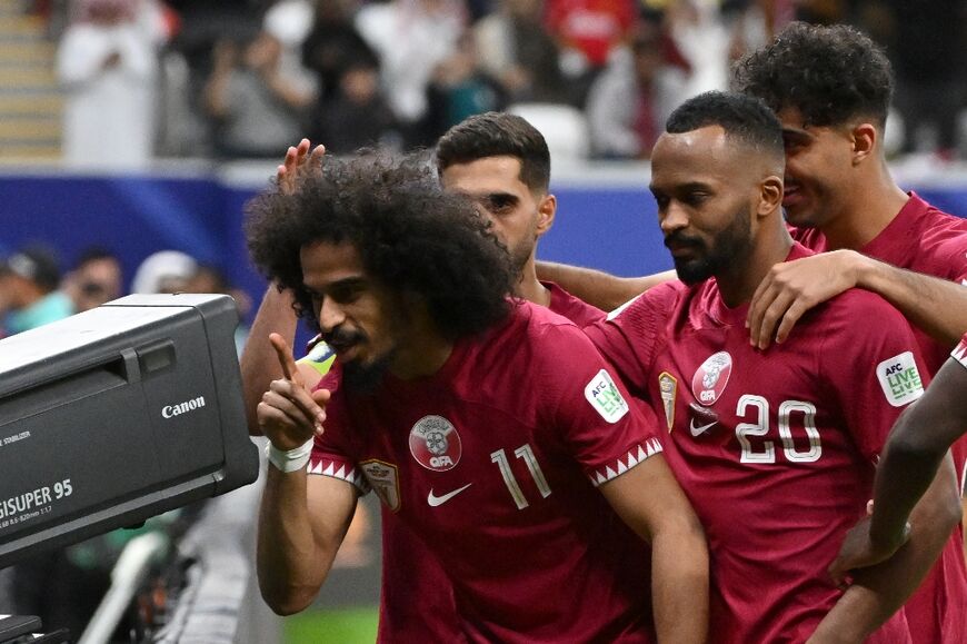 Qatar's forward Akram Afif celebrates scoring his penalty