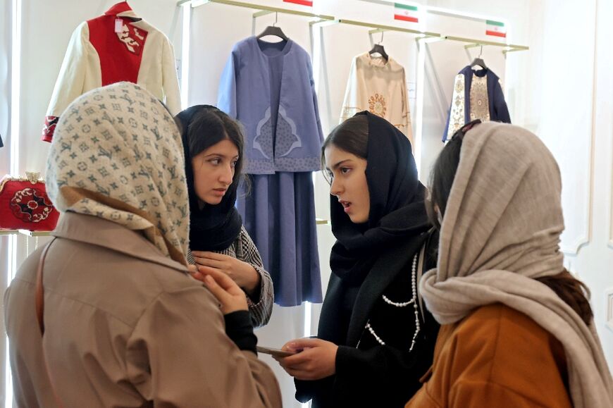 Visitors to the exhibition discuss some of the designs on show