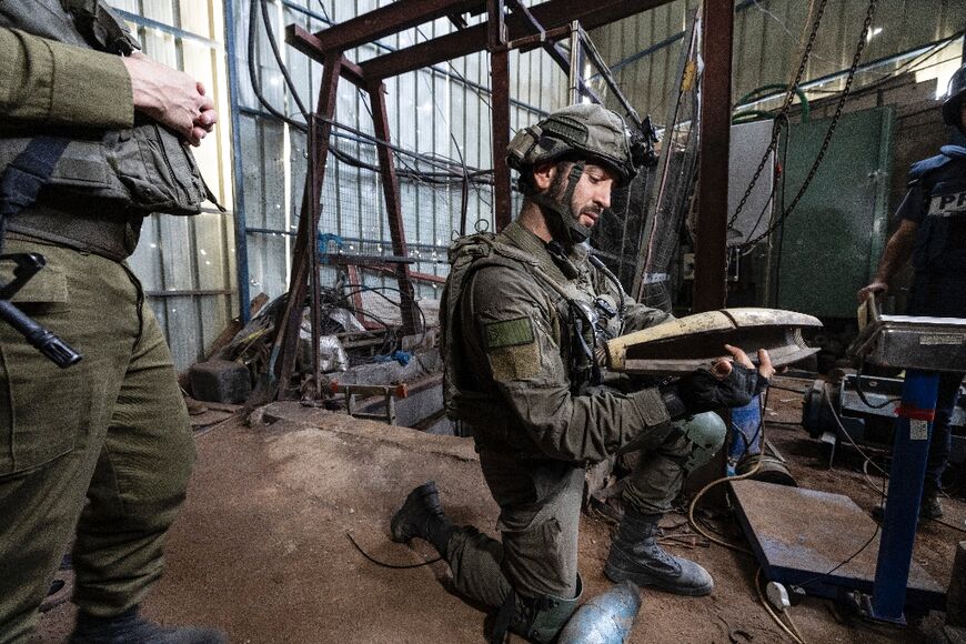 An Israeli soldier holds a mortar shell inside what the army said was a Hamas weapons factory during a media tour on Monday