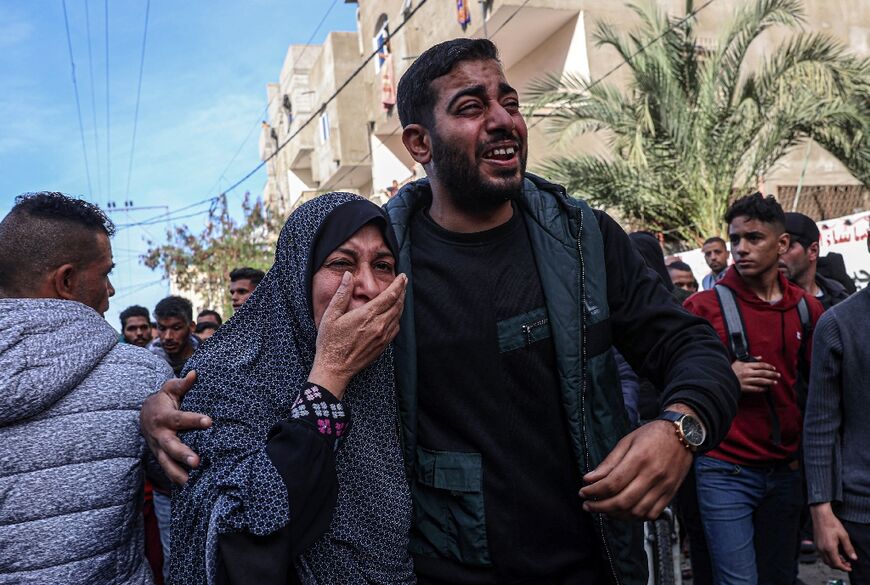 Relatives in Rafah react after the body of a victim was found after a strike on a car