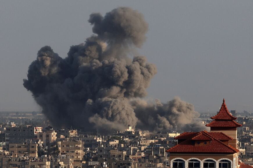 Smoke billows over Khan Yunis in the southern Gaza Strip during Israeli bombardments on January 24, 2024