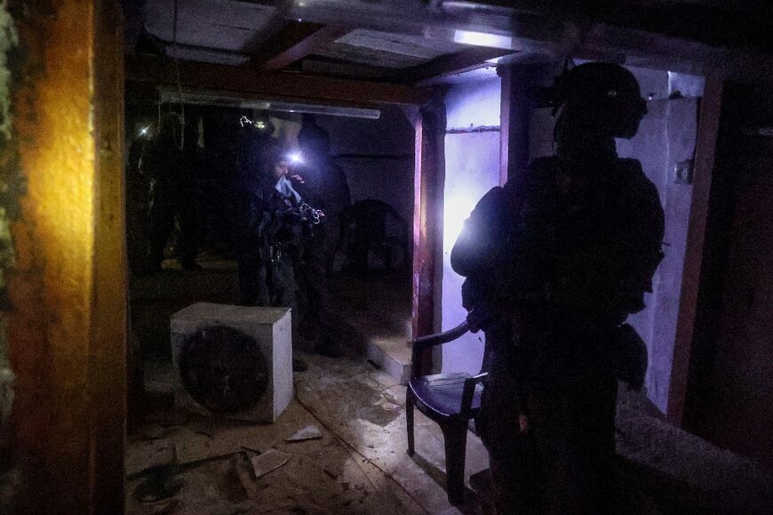 This picture taken during a media tour organised by the Israeli military on January 27, 2024 shows Israeli soldiers inspecting a tunnel, which had been dug by Hamas militants according to the Israeli army, in Gaza's main southern city of Khan Yunis