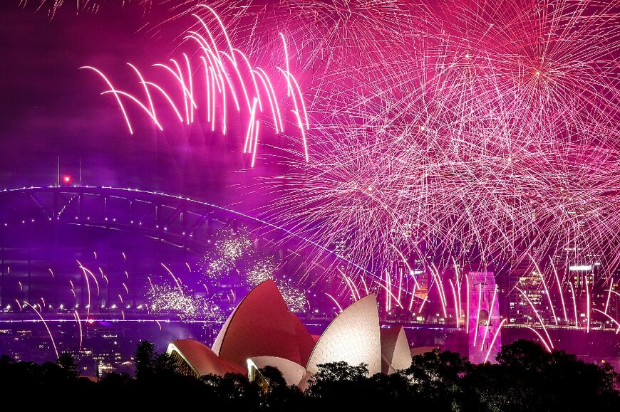 Fireworks explode over the Sydney Harbour Bridge and Sydney Opera House
