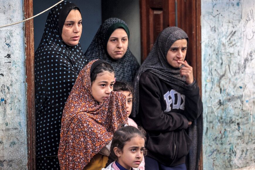 Women and girls look at an area that was hit in  bombardment on Rafah in the southern Gaza Strip on February 7, 2024