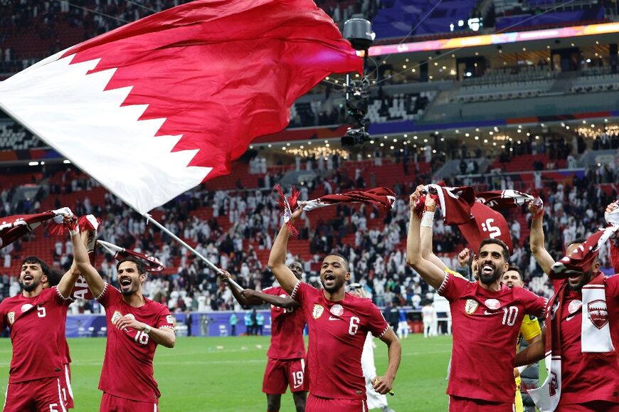 Qatar's players celebrate their win over Uzbekistan