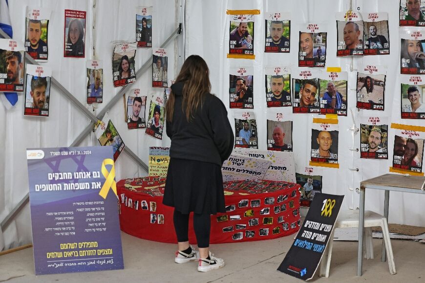 A woman looks at portraits of hostages taken by militants from Gaza on October 7