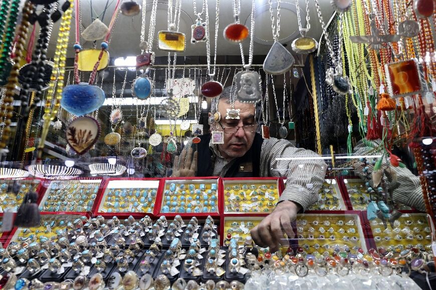A seller displays stone rings at his shop in the city of Shahr-e Ray