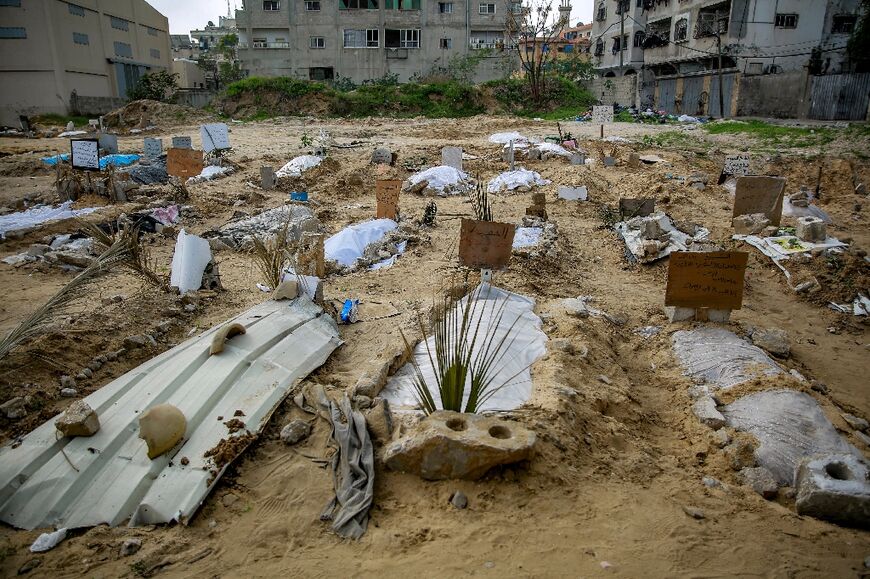 Shallow graves at a makeshift cemetery in a residential neighbourhood near Gaza City's al-Shabiyah district 