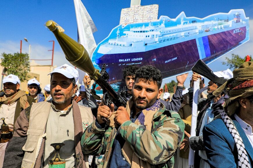 A sign depicts the cargo vessel Galaxy Leader, which was seized by Yemen's Huthi rebels, at a pro-Palestinian rally in the Huthi-held capital Sanaa on February 7, 2024 