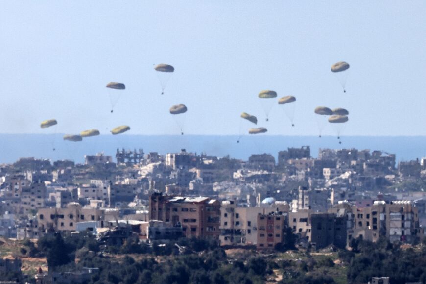 Seen from Israel, humanitarian aid is airdropped over the Gaza Strip