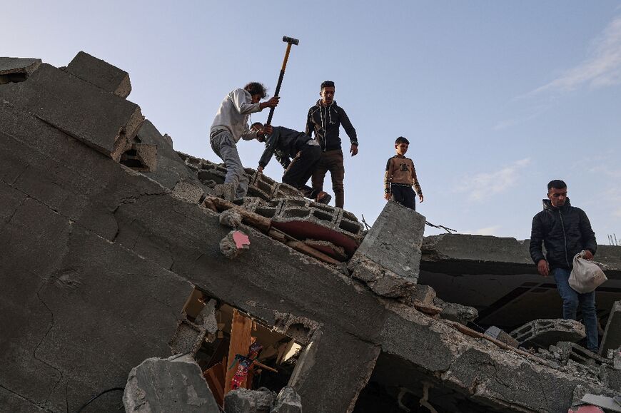 Men searched for survivors in the rubble of the bombed Abu Anza family home in Rafah, the southern Gaza Strip