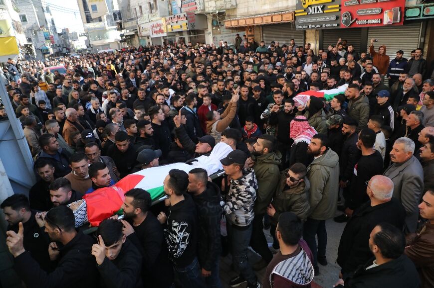 Mourners at the January 16, 2024 funeral in Dura of Palestinians Ahed Mahmoud Mohammed and Muhammad Abu Sebaa, a day after they were killed when Israeli forces stromed the West Bank town
