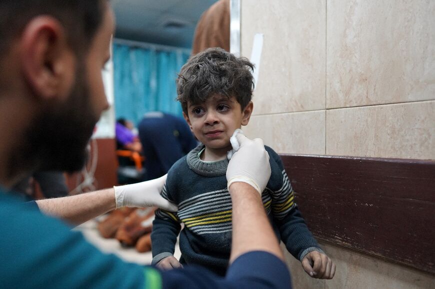 A Palestinian child receives medical attention at a Gaza hospital following an Israeli bombing