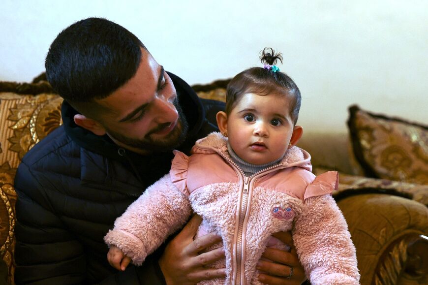 Palestinian widower Bahaa Al-Masalmeh with his baby daughter 