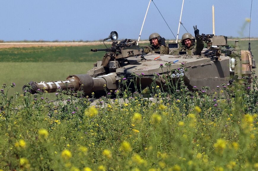 An Israeli tank moves along the border with the Gaza Strip