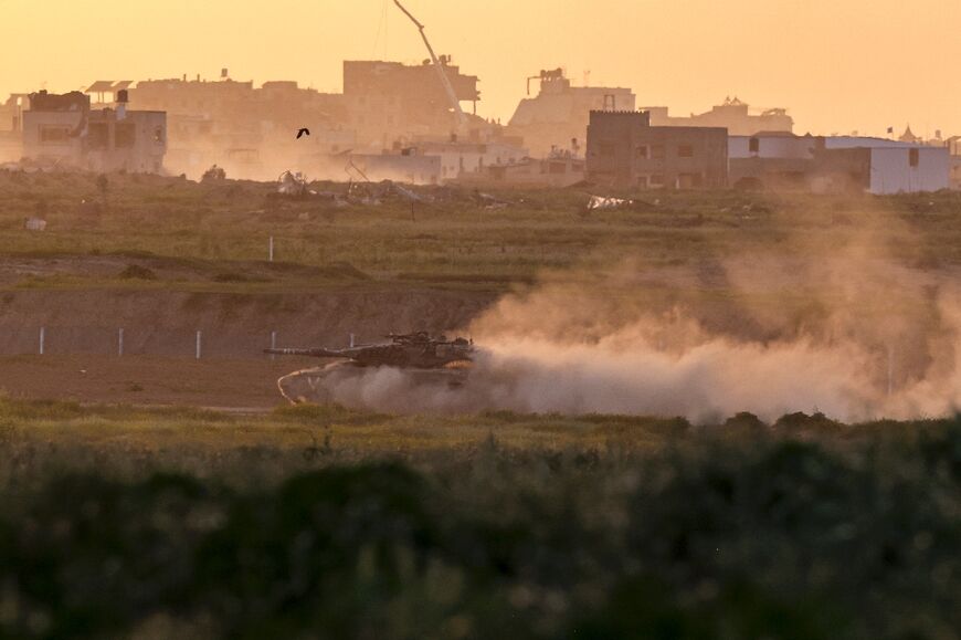 An Israeli armoured vehicle moves along the border with the Gaza Strip