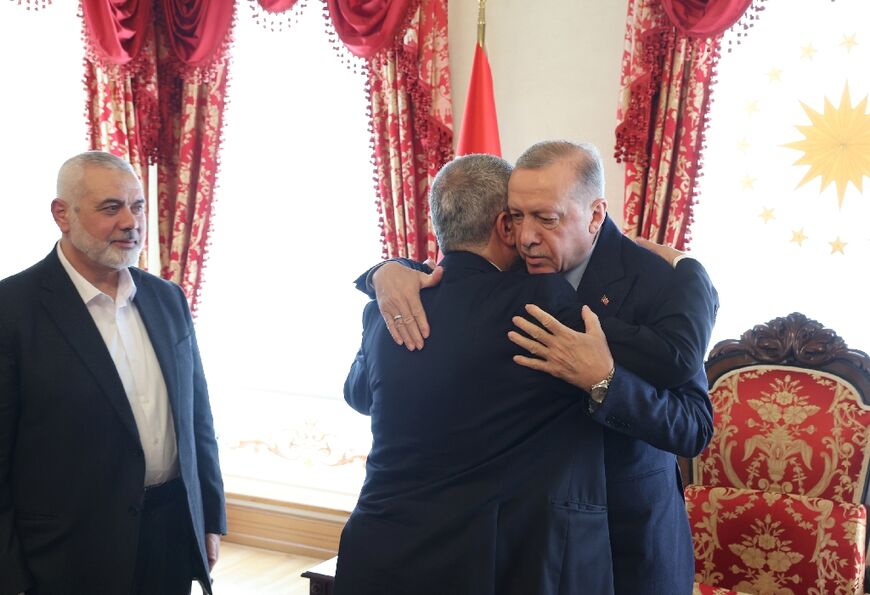President Recep Tayyip Erdogan embraces Qatar-based Hamas leader Ismail Haniyeh