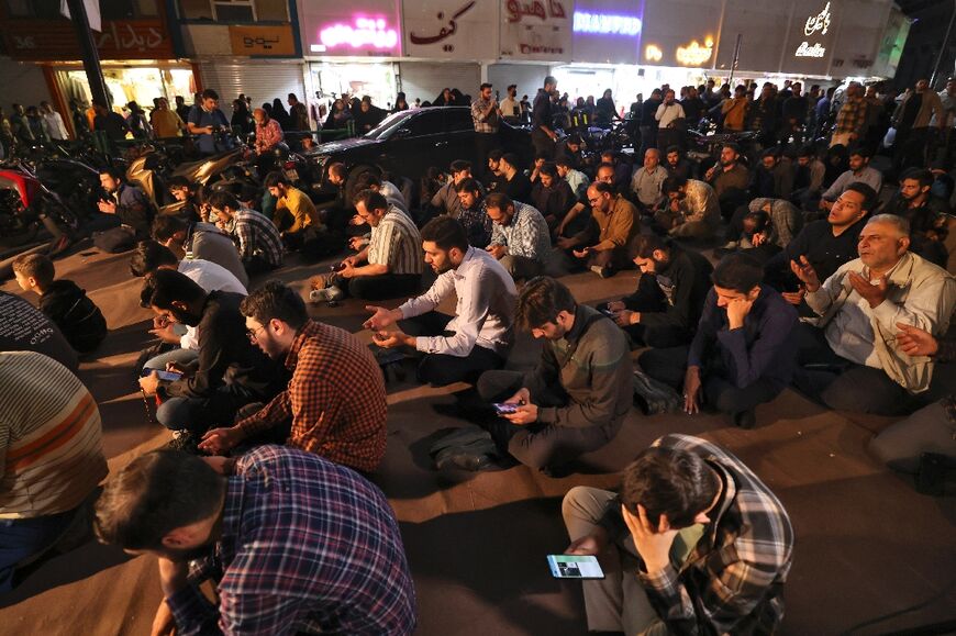 Iranians pray for President Ebrahim Raisi and Foreign Minister Hossein Amir-Abdollahian in Valiasr Square in central Tehran 