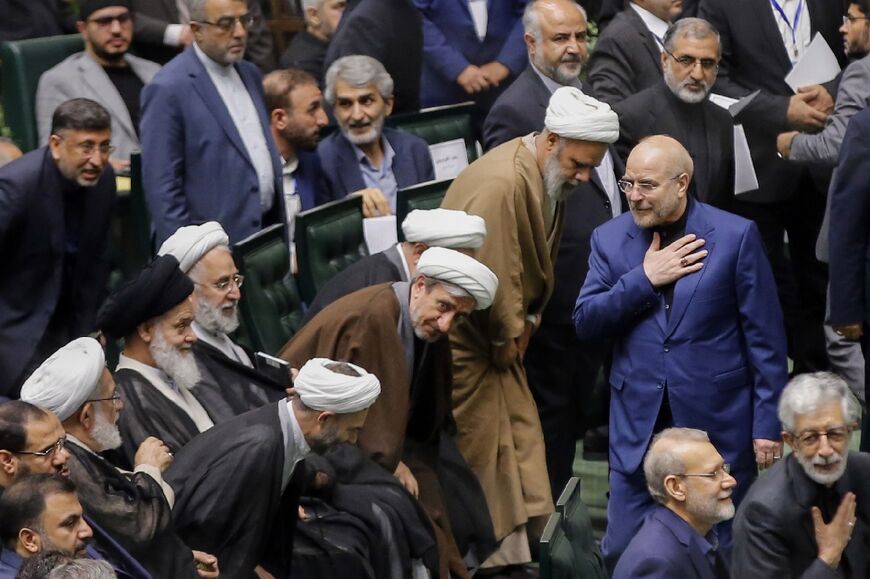 Iran's Parliament Speaker Mohammad Bagher Qalibaf greets lawmakers during the inauguration session for the new Parliament in Tehran on May 27, 2024