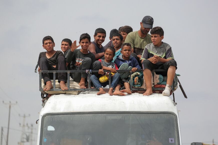 A truck piled with people evacuated from Rafah arrives in Khan Yunis