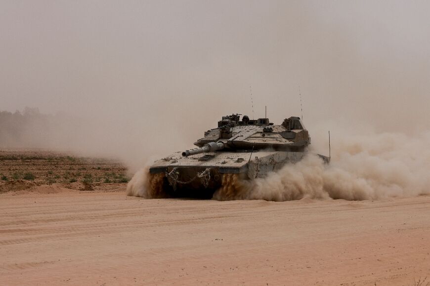 An Israeli army tank rolls along Israel's southern border with the Gaza Strip on May 28, 2024