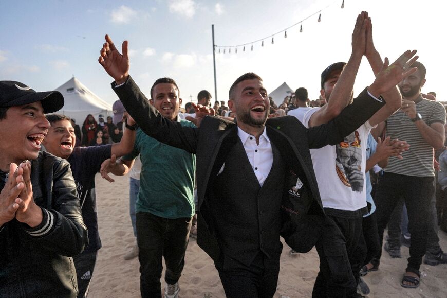 A groom celebrates during the mass wedding in Khan Yunis