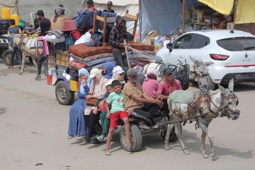 Donkey carts loaded with people and belongings