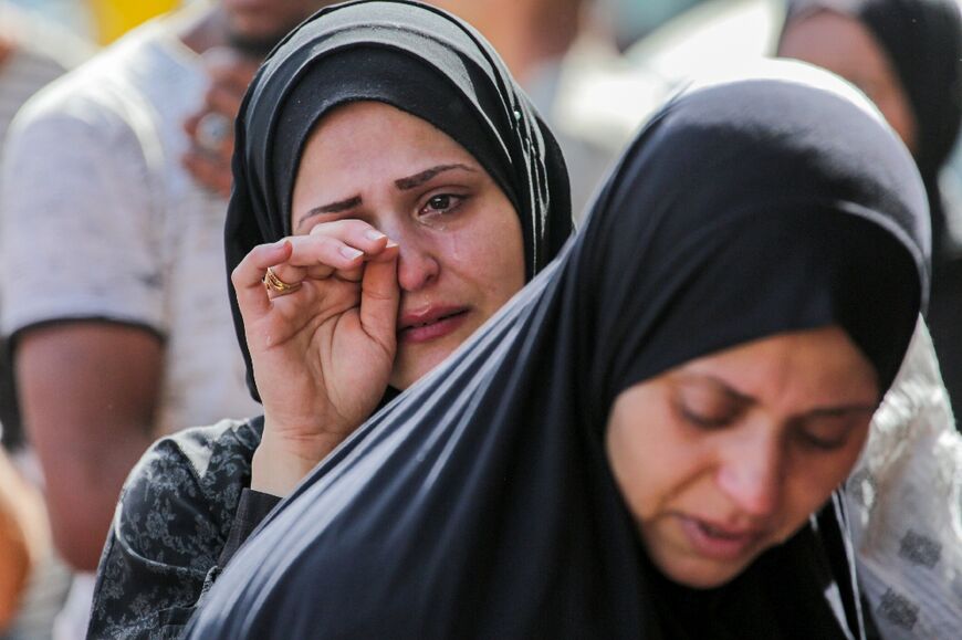 A Palestinian woman cries after identifying victims at the Al-Aqsa Martyrs Hospital in Deir al-Balah following Israeli bombardment overnight on May 23, 2024