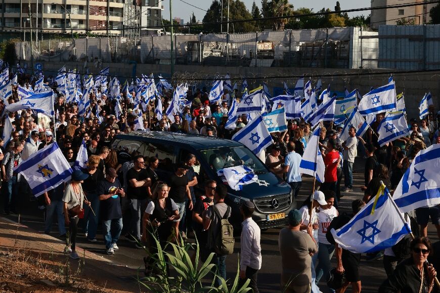 Many mourners at Chanan Yablonka's funeral carried Israeli flags