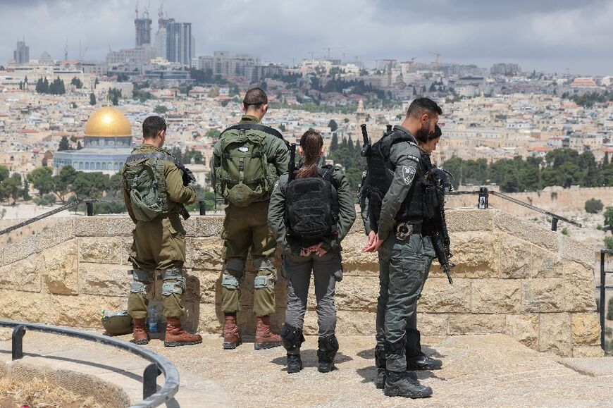 Israeli soldiers gather on the Mount of Olives, overlooking Jerusalem's Old City, on Israel's Memorial Day for fallen soldiers 