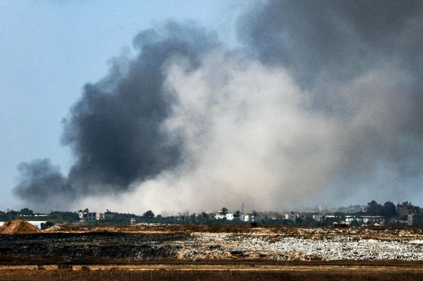 A smoke plume from an explosion billows in the Gaza Strip as seen from a position along Israel's southern border with the Palestinian territory