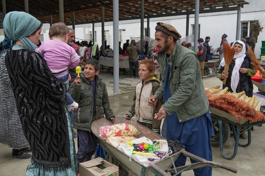 Tajiks and Afghans buy and sell in the border bazaar in the Tajik town of Kalai-Khumb 